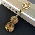 Creative violin keychain pendant with amber rhinestones and golden metal lobster clasp - Antique Gold