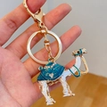 Blue enamel and rhinestone camel keychain in gold alloy shown in hand display - Blue