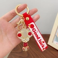 Golden lucky charm keychain with white oval stone and red silicone wrist strap - Ruyi Red