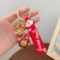 Lucky red fortune bag keychain with gold finish, crystals and red silicone strap - Wealth Fortune