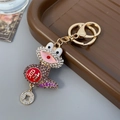 Goldener Frosch-Schlüsselanhänger mit Strasssteinen und roter Glücksmünze - Lila