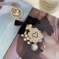 Bow pearl perfume bottle keychain with black velvet ribbon and sparkling rhinestones - White