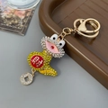 Yellow and white crystal snake keychain with gold character and coin pendant - Yellow
