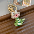 Sparkling cartoon snake keychain with green and white rhinestones on golden metal base - Individual Packaging / Green