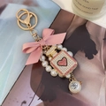 Pink ribbon bow keychain with pearl strap and rhinestone perfume bottle charm - Pink