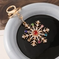 Portachiavi fiocco di neve con strass colorati su base in metallo dorato e cristalli - Fiocco di neve multicolore