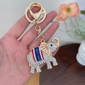 Sparkling Thai elephant keychain in gold finish with white crystals and Thailand script - White