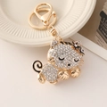 Golden cat keychain pendant with sparkling rhinestones and black enamel detail for bags - White