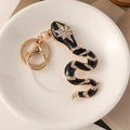 Portachiavi a forma di serpente in smalto con strass in finitura nera e oro - Nero