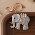 Olifant sleutelhanger met zilveren glitter en gouden frame met witte kristallen - Zilver
