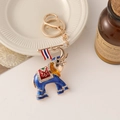 Blue elephant keychain with gold trim, red saddle, rhinestones and Thai flag detail - Blue
