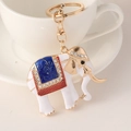 White enamel elephant keychain with blue pattern and rhinestones on gold ring - White