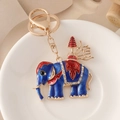 Porte-clés éléphant en émail bleu avec strass brillants et placage d'or sur assiette blanche - Bleu foncé