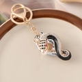 Golden zodiac snake keychain with black and white enamel and sparkling rhinestones - Black