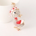 Cute duck keychain with white crystals and red polka dot hat on a gold metal base - Red