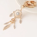 Golden dreamcatcher keychain with white rhinestones and feathered tassels for bags - White