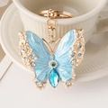 Goldener Schmetterling-Schlüsselanhänger mit blauer Emaille und funkelnden Perlen - Blau