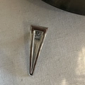 Detailed close-up of a polished silver metallic hollow triangle hair clip on grey fabric - Glossy Large Hollow Triangle Style