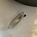 Detail of silver metallic hollow oval hair clip with sturdy crocodile grip mechanism - Glossy Oval Hollow Style