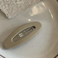 Matte finish khaki oval hair clip for women displayed on a ceramic dish - Milk Tea Oval Hair Clip