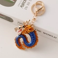 Golden zodiac dragon keychain with blue and orange enamel finish and rotating ring - Blue