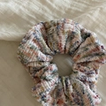 Macro detail of a colorful knitted hair scrunchie with a silver metal Lovedays tag - 2# White Blue Orange Scrunchie