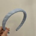 Detailed view of light blue pleated fabric headband with padded thick vintage texture - Blue
