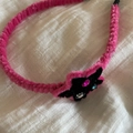 Detailed view of a pink plush headband with a black star patch and colorful rhinestones - Rose Red Edge Black Star Headband