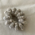 Detailed close-up of a warm wool-wrapped spiral hair tie in grey and beige knit texture - Beige Wool Phone Line Coil