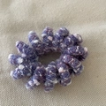 Detail of purple knitted wool wrap on elastic spiral hair tie with soft texture - Purple