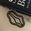 Dark grey leather cloud-shaped hair clip with stitched edges and a wave design - Gray