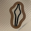 Close-up of a brown leather cloud-shaped hair clip with decorative stitching and wave edges - Milk Tea