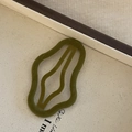 Olive green velvet wavy hair clip with hollow design on a neutral canvas background - Flocked Hair Clip / Ginger Green