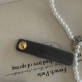 Grey velvet rectangle hair clip with gold buckle on beige canvas backdrop - Gray Hair Clip With Gold Buckle