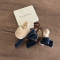 Detail view of plush bear hair tie with denim bow and elastic band on wooden table - Milk Tea Bear Dark Blue Denim (Hair Tie)
