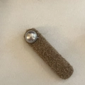 Close-up of brown plush rectangular hair clip with a large white pearl accent - Khaki