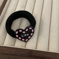 Elastic black hair tie with a black heart charm featuring Like text and pink dots - Black Heart Black Rope