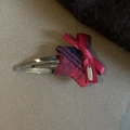 Detail of red and blue plaid star hair clip with red ribbon bow and golden metal tag - Blue and Red Star Snap Clip