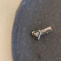 Detail view of a shiny silver heart-shaped hair clip with sleek y2k aesthetic design - Duckbill Hair Clips / Silver Black Outline Heart