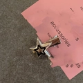 Y2K style silver star hair clip with black star detail on pink cardstock display - Duckbill Hair Clips / Silver Black Outline Star