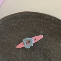Sweet pink and blue contrast duckbill hair clip with polished finish on a ceramic plate - Blue Heart Pink Strip