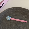 Close-up of pink and blue contrast star hair clip with rhinestone in a ceramic dish - Blue Flower Pink Strip