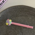 Detailed view of pink and blue contrast duckbill hair clip on a textured ceramic plate - Colorful Polka Dot Pink Strip