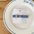 Blue denim BB hair clip featuring a golden 3D bear, rhinestone heart, and Kissme text - Dark Denim Blue Bear Hair Tie