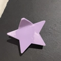 Macro detail of the glossy light purple star-shaped hair claw clip on dark stone surface - Purple Pentagram