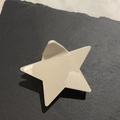Macro detail of star-shaped acetate hair claw clip in creamy white on a slate background - Milky White Pentagram