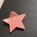 Pink star-shaped hair claw clip in glossy finish on a dark textured background - Red Pentagram
