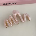 Detail of pink marble acetate hair claw with wave design and golden metal frame - #1 Pink Textured Wave Claw Clip