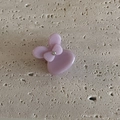 Close-up of a small light pink acetate hair claw clip with a bow design and rhinestone - Solid Purple Rabbit Claw