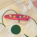 Detailed macro view of a peach pink Y2K hair clip with neon stars and colorful rhinestones - Rose Pink Oval Hair Clip (11)